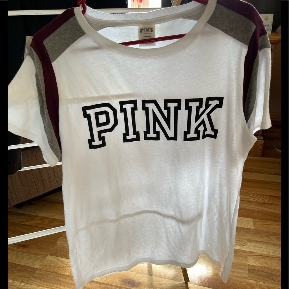 Pink brand t-shirt White in color with black lettering, burgundy on the shoulder